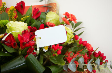 Bouquet of flowers and empty tag on white background. Wedding. Mothers Day. Valentine's Day. Birthday. Happy woman's day.