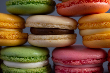 Sweet French macaroons close-up on a dark background.