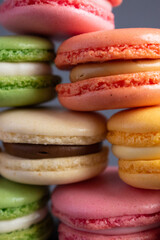 Sweet French macaroons close-up on a dark background.