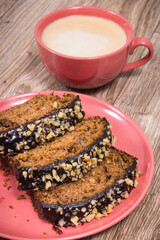 Fresh pastry made of zucchini and cup of white coffee. Delicious dessert. Wooden background