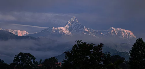 Cercles muraux Himalaya View of Machapuchare (Fish-Tial) mountain at foggy sunrise, situated in the Annapurna mountain massif, North of Pokhare, as seen from Pokhara, Nepal Himalayas, Nepal
