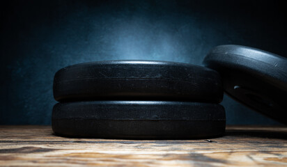 Dumbbell barbell weight plates stacked on top of each other. Healthy fitness lifestyle composition....