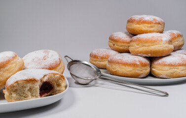 Pączki deep-fried Polish doughnuts and mini strainer with powdered sugar. Celebrating Fat...