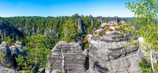 Panoramic over monumental Bastei sandstone pillars, rock formation and stacks surrounded by ancient...