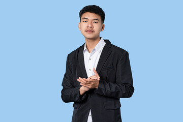 Young handsome asian businessman smiling proud clapping isolated on blue light background
