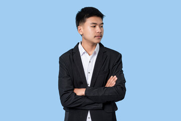 Portrait of Young handsome asian Business Person isolated on blue light background