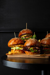 Close up of set Tasty burgers  fast food on black table - 579444043