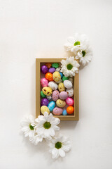 Easter candy small eggs top view holiday background
