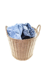 Clothes in a laundry wooden basket isolated on white background. Clipping path.
