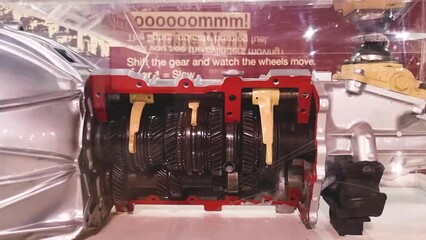 Footage of the cutaway automotive gear box, displaying shifting of the gears. Engineering