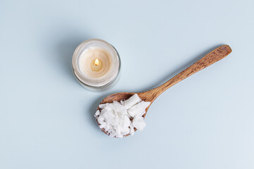 Handmade candle and soy or coconut wax on spoon. Top view. Natural wax