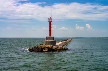 breakwater and lighthouse at the entrance to the port