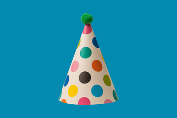 Bright and colorful birthday cap isolated on a blue background.
