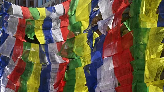 Prayer flags blowing by the wind in sacred place in rural Nepal.