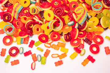Assorted colorful gummy candies. Top view. Jelly donuts. Jelly bears. Isolated on a white background.