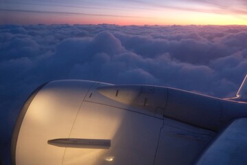 Fototapeta na wymiar Beautiful views of clouds in sunrise light and sky through the plane window