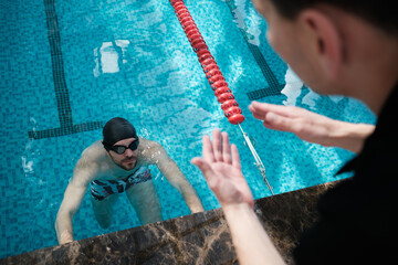 Swimming pool - swimmer training competition in class with coach