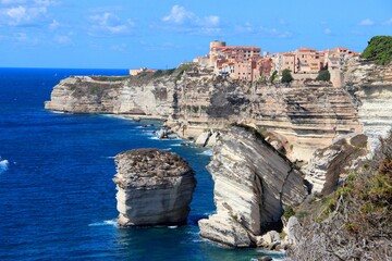 Beautiful shot of Bonifacio citadel above limestone cliff overlooking the sea on clear blue sky