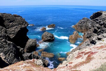 Scenic view of a rocky shore under the bright sunlight