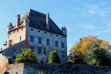 Fototapeta na wymiar Facade of the Chateau d'Yvoire against a blue cloudy sky