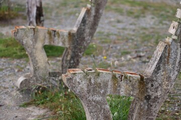 a row of wooden benches with broken and chipped seats