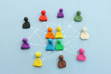 Colorful figures connected over blue background, concept of human resources and collaboration.