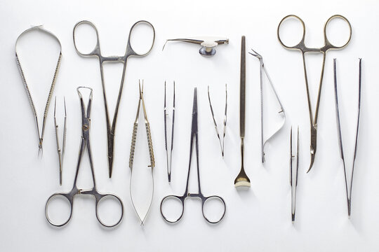 Medical surgical instruments, ophthalmological, laid out on white background