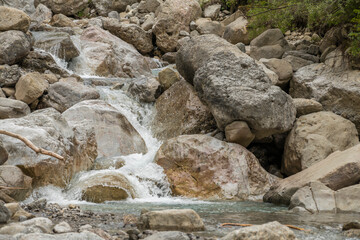 Close-up of small waterfalls between boulders in a wild river in the Austrian Alps, Imst.