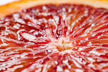 Bloody red orange kara-kara, cut lobule sectors close-up macro, side view selective focus