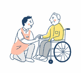 笑顔で話す車いすのシニア男性と介護スタッフ