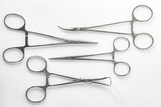 Surgical hemostatic clamps made of stainless steel, on white background