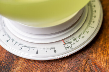 mechanical kitchen scales on wooden background. Measurement of weight of products for cooking.
