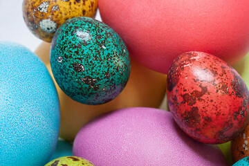 Colorful painted Easter eggs in the glass bowl on the white background. Close up