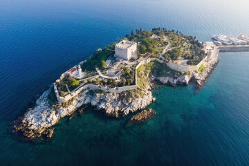 Aerial view of Guvercinada Island with scenic castle at sunrise light, Kusadasi in Turkey