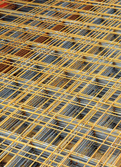 Mesh of steel rods for reinforced concrete construction. Electro-welded rebar mesh stored for works. Construction materials