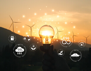 Renewable energy, clean technology concept. Light Bulb and ecosystem icons on wind turbine and nature background