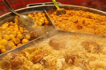 Street food on the tourist street of Poland. Fried potatoes, cabbage with sausage, drumstick