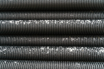 Texture of black corrugated pipes. Industrial textures.