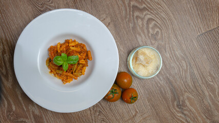 malloreddus or Sardinian gnocchetti, typical Sardinian pasta, with wild boar sauce, basil and pecorino cheese
