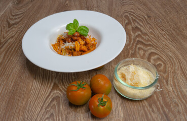 malloreddus or Sardinian gnocchetti, typical Sardinian pasta, with wild boar sauce, basil and pecorino cheese
