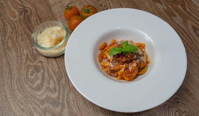 malloreddus or Sardinian gnocchetti, typical Sardinian pasta, with wild boar sauce, basil and pecorino cheese
