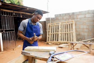 young african carpenter standing holding working