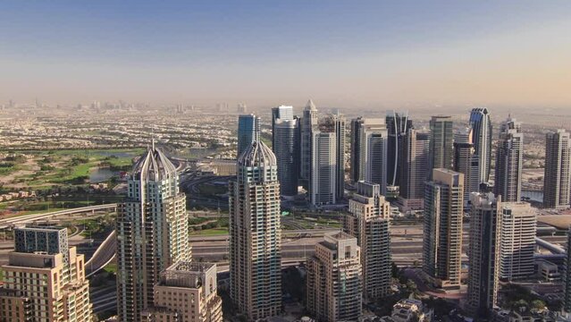 Modern buildings in Dubai Marina with shadows moving very fast from morning untill evening aerial timelapse, Dubai, UAE. Towers and skyscrapers from above with many yachts and boats