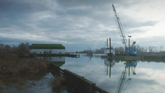A boat slowing coming to shore at the port of Steveston pier