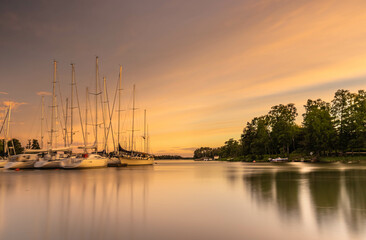 Amazing sunset over the harbor in Finland. A landscape with sunset ,boats in the harbor and an...