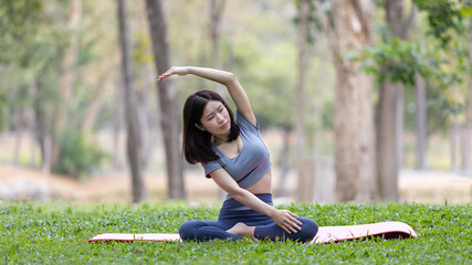 Asian woman doing yoga in nature in the forest, Meditation and breathing exercises, Treat ADHD and train your mind to be calm, Healthy exercise, Mindfulness, Homeopathy, Park yoga.