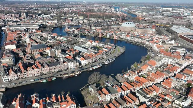Soar over the historical landmarks and picturesque city center of Haarlem with this breathtaking drone video, featuring the former Koepelgevangenis and Molen De Adriaan.