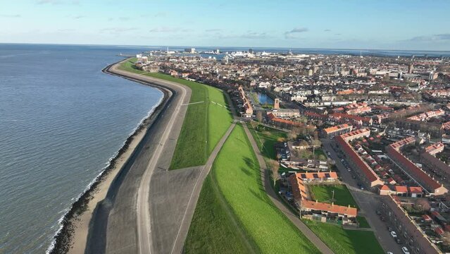 A bird's-eye view of Den Helder reveals the stunning juxtaposition of cityscape and coastline, creating a breathtaking visual experience.