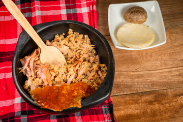 Lechona with rice, arepa and potato