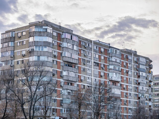 Worn out apartment building from the communist era against blue sky in Bucharest Romania. Ugly...